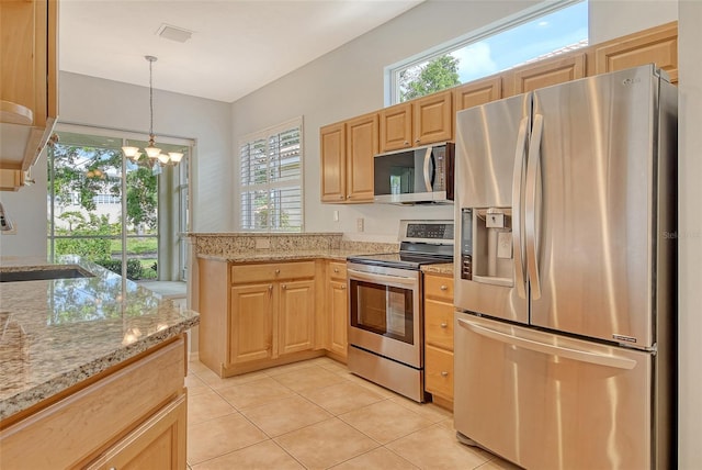 kitchen with appliances with stainless steel finishes, a sink, light brown cabinets, and light tile patterned floors