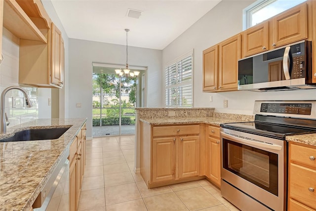 kitchen featuring appliances with stainless steel finishes, a sink, a chandelier, light brown cabinetry, and light stone countertops