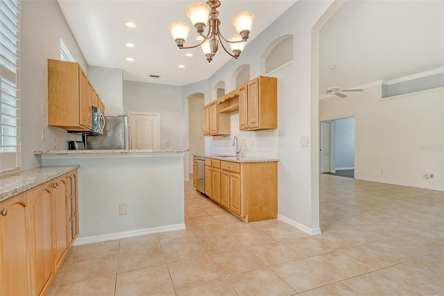 kitchen featuring stainless steel appliances, a sink, a ceiling fan, a chandelier, and light tile patterned flooring