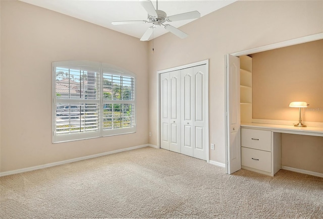 unfurnished bedroom featuring light carpet, a closet, and baseboards