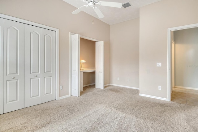 unfurnished bedroom with carpet, baseboards, a closet, and a ceiling fan