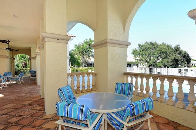 view of patio featuring outdoor dining area, a ceiling fan, and fence