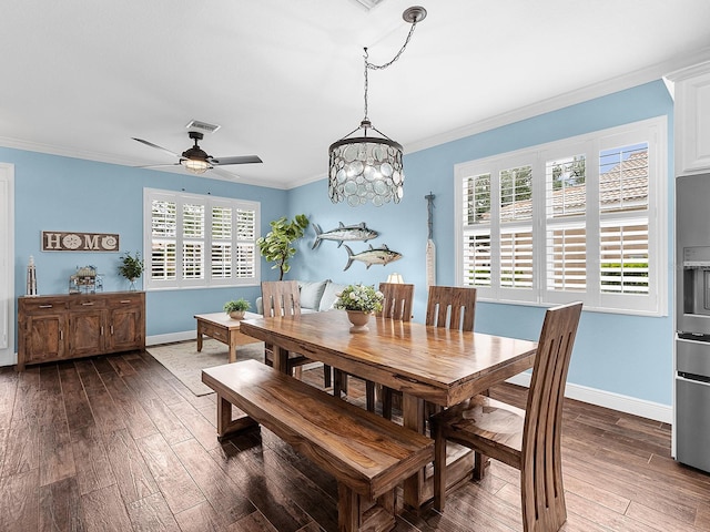 dining area with ornamental molding, dark wood-style flooring, baseboards, a ceiling fan, and a chandelier