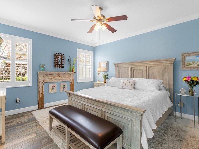 bedroom featuring multiple windows, baseboards, wood finished floors, ornamental molding, and a ceiling fan