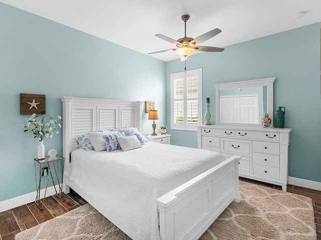 bedroom featuring wood finished floors, baseboards, and a ceiling fan