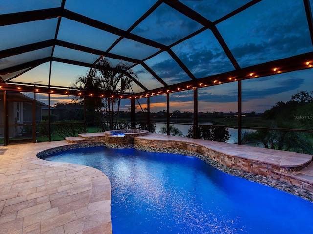 view of pool featuring a patio, a water view, a lanai, and a pool with connected hot tub
