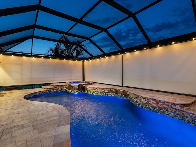 view of pool with a lanai, a patio, and a pool with connected hot tub