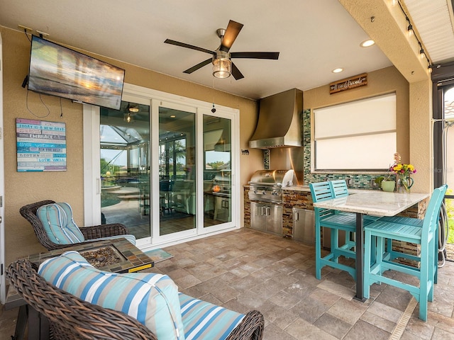 sunroom with area for grilling, a ceiling fan, and an outdoor hangout area