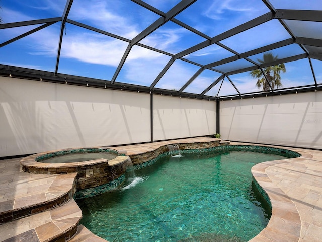 view of pool featuring a pool with connected hot tub and glass enclosure