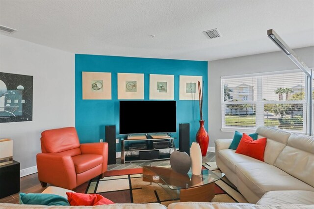 3430 77th St W Unit 103, Bradenton, FL 34209 - living area featuring baseboards, wood finished floors, and a textured ceiling