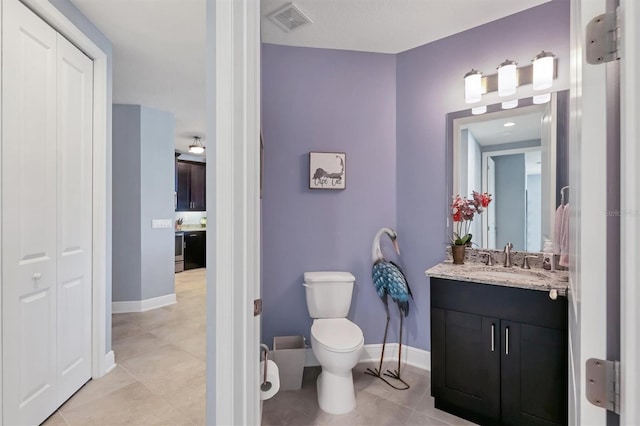 3430 77th St W Unit 103, Bradenton, FL 34209 - bathroom with toilet, vanity, tile patterned floors, and baseboards