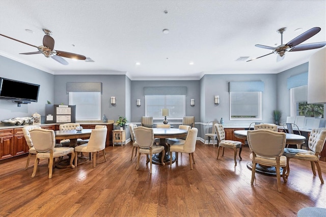 3430 77th St W Unit 103, Bradenton, FL 34209 - dining space featuring healthy amount of natural light, wood finished floors, a ceiling fan, crown molding, and recessed lighting
