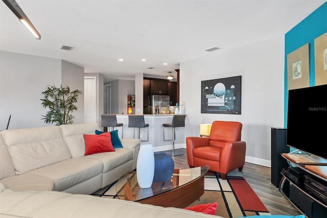 3430 77th St W Unit 103, Bradenton, FL 34209 - living room featuring recessed lighting, baseboards, and wood finished floors