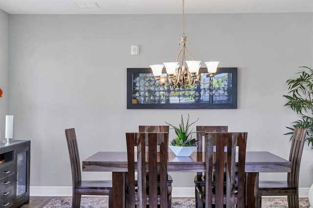 3430 77th St W Unit 103, Bradenton, FL 34209 - dining area featuring a chandelier and baseboards