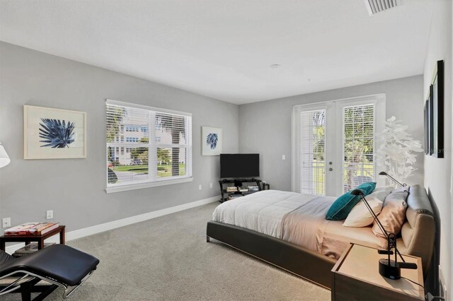 3430 77th St W Unit 103, Bradenton, FL 34209 - bedroom featuring access to exterior, french doors, carpet flooring, and baseboards