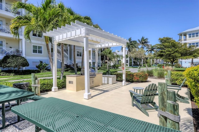 3430 77th St W Unit 103, Bradenton, FL 34209 - view of patio with an outdoor kitchen, a pergola, and a grill