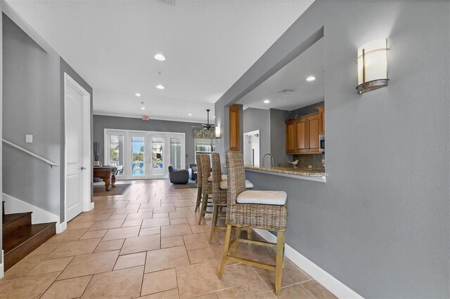 3430 77th St W Unit 103, Bradenton, FL 34209 - corridor featuring recessed lighting, stairway, a sink, baseboards, and french doors