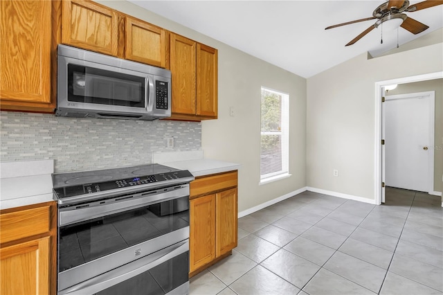 2499 Trimble Ave, North Port, FL 34288 - kitchen featuring appliances with stainless steel finishes, vaulted ceiling, backsplash, a ceiling fan, and light countertops