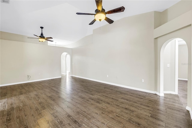 2499 Trimble Ave, North Port, FL 34288 - empty room featuring arched walkways, a ceiling fan, dark wood-style floors, baseboards, and high vaulted ceiling