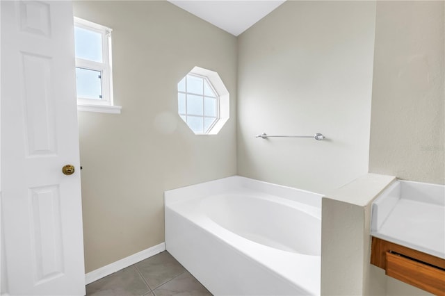 2499 Trimble Ave, North Port, FL 34288 - bathroom with a garden tub, tile patterned floors, and baseboards