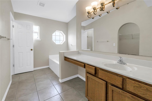 2499 Trimble Ave, North Port, FL 34288 - bathroom featuring tile patterned floors, vanity, a garden tub, and baseboards