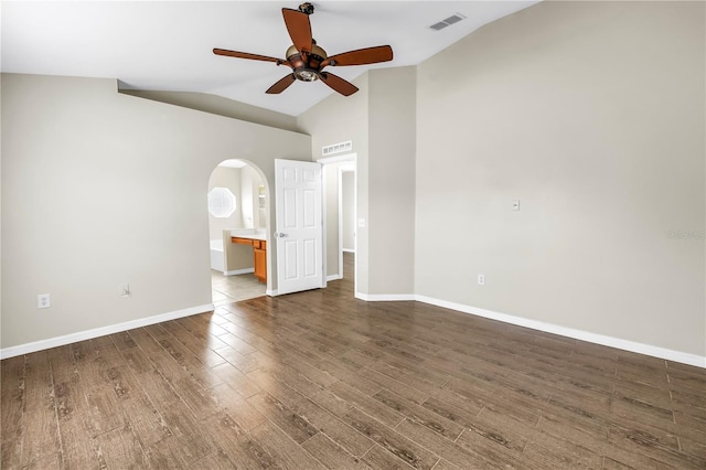 2499 Trimble Ave, North Port, FL 34288 - empty room with arched walkways, ceiling fan, wood finished floors, baseboards, and high vaulted ceiling