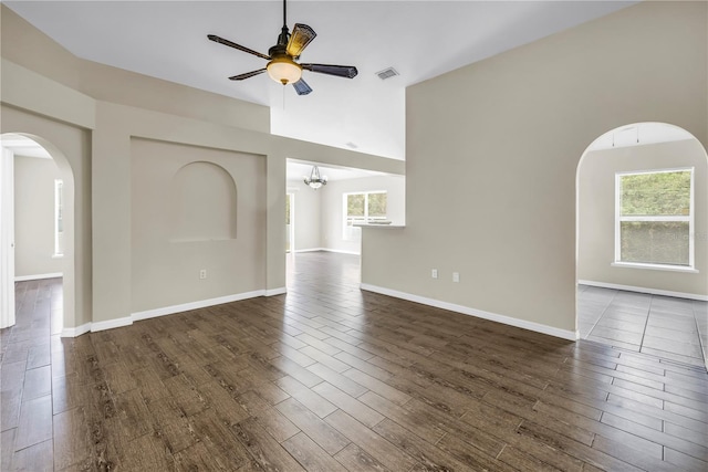 2499 Trimble Ave, North Port, FL 34288 - spare room with ceiling fan, dark wood-type flooring, arched walkways, high vaulted ceiling, and baseboards