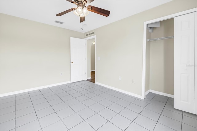 2499 Trimble Ave, North Port, FL 34288 - unfurnished bedroom featuring a closet, light tile patterned flooring, baseboards, and ceiling fan