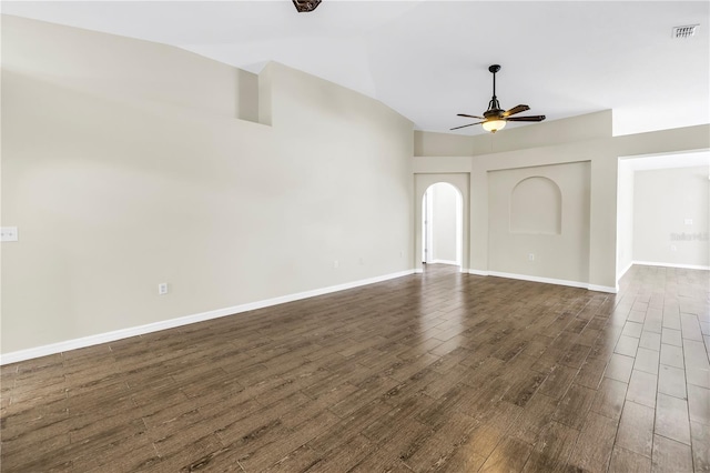 2499 Trimble Ave, North Port, FL 34288 - unfurnished living room with ceiling fan, lofted ceiling, dark wood finished floors, baseboards, and arched walkways
