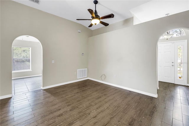 2499 Trimble Ave, North Port, FL 34288 - unfurnished room featuring arched walkways, plenty of natural light, and dark wood finished floors