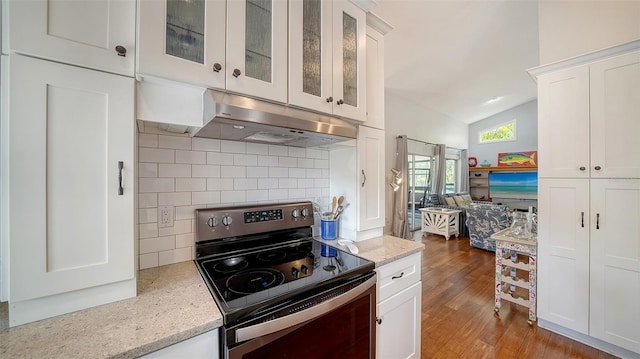 kitchen with stainless steel range with electric cooktop, under cabinet range hood, tasteful backsplash, white cabinets, and wood finished floors