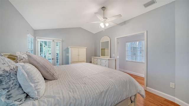 bedroom featuring light wood-style floors, vaulted ceiling, baseboards, access to exterior, and a ceiling fan