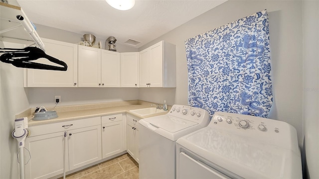 clothes washing area featuring cabinet space and washing machine and clothes dryer