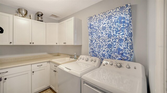laundry area featuring cabinet space and washing machine and dryer