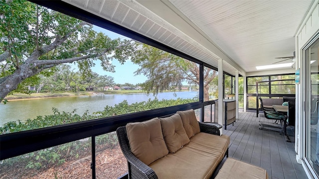 sunroom / solarium with a water view, a ceiling fan, and outdoor lounge area
