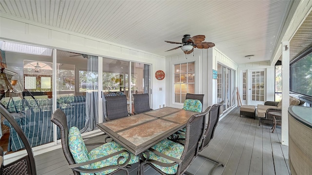 sunroom / solarium with a ceiling fan, outdoor dining space, and healthy amount of natural light