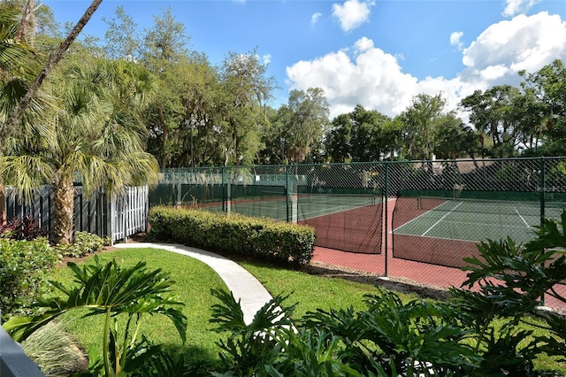 view of tennis court featuring fence