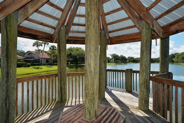 dock area featuring a water view and a lawn