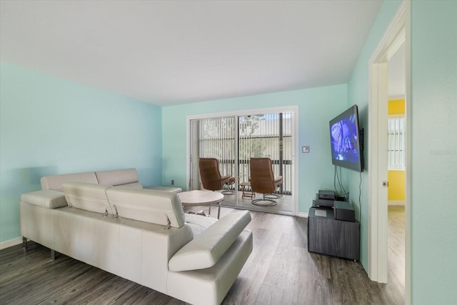 living area with wood finished floors and baseboards