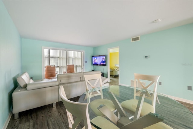 dining room with wood finished floors and baseboards