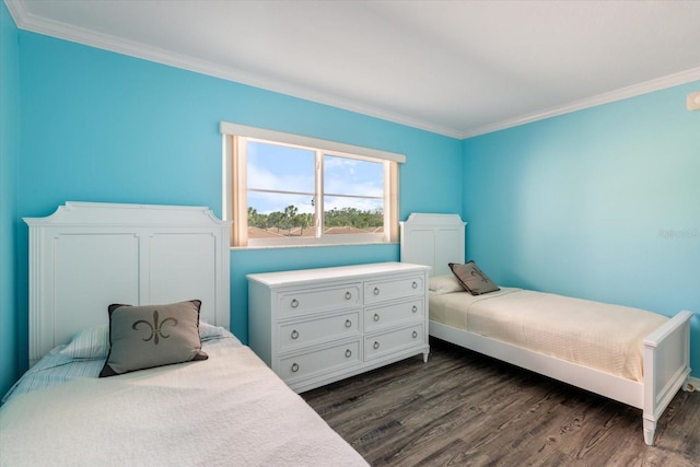 bedroom with ornamental molding, dark wood-type flooring, and baseboards