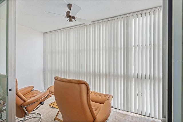 sitting room with ceiling fan