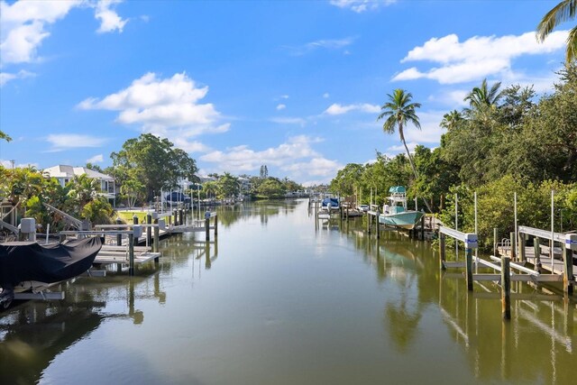 dock area featuring boat lift and a water view