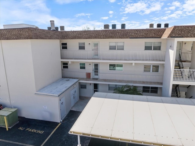 view of property featuring uncovered parking