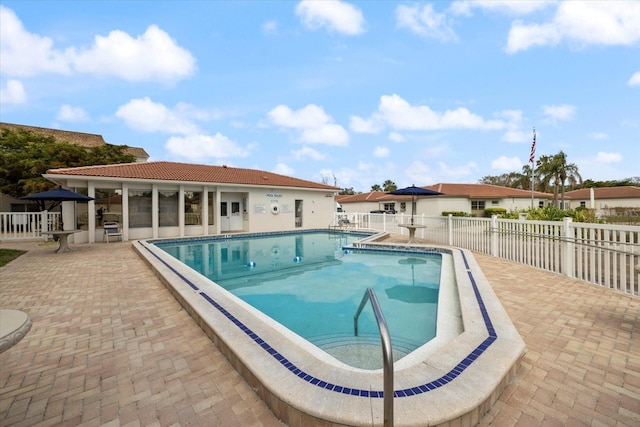 community pool featuring a patio area and fence