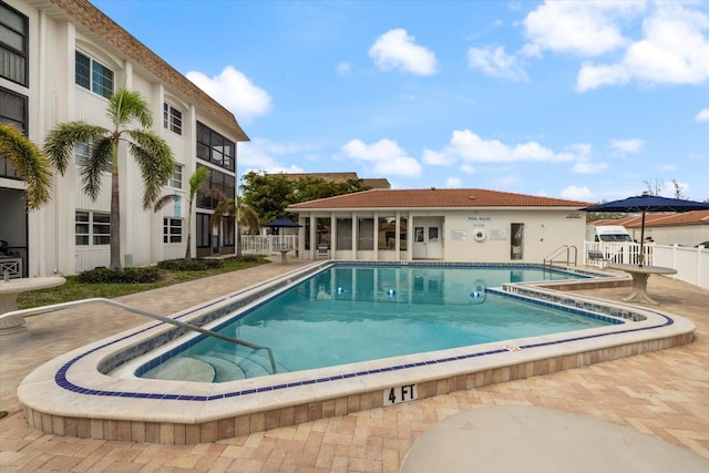 community pool with a patio area