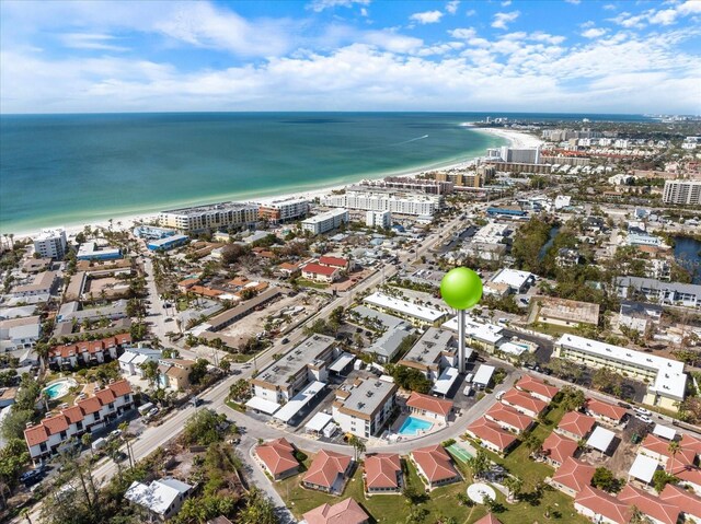 view of property location with expansive beach and nearby urban area
