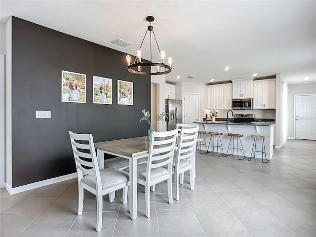 dining room featuring recessed lighting, a chandelier, light tile patterned floors, and baseboards