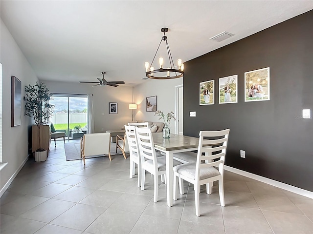 dining room featuring ceiling fan, a chandelier, baseboards, and light tile patterned floors