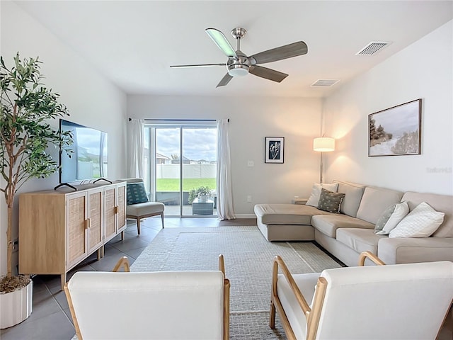 living room with ceiling fan and tile patterned flooring